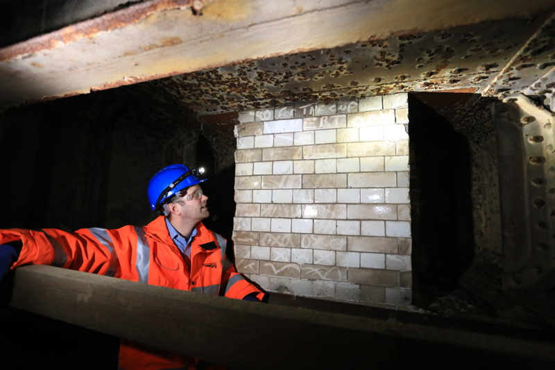 Greg Thornett inspects tiles from the old Southwark Park Railway Station